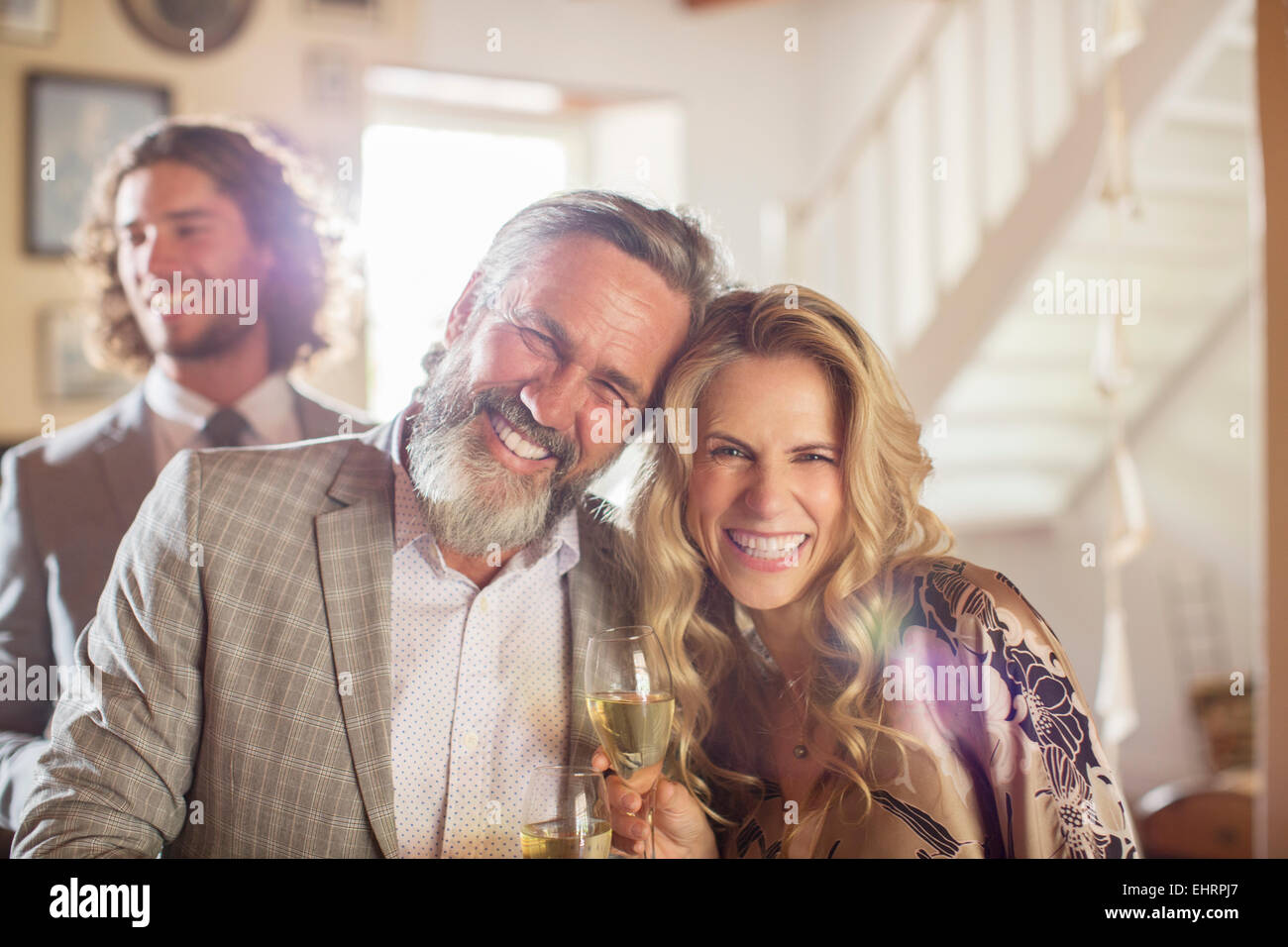 Portrait of smiling matron of honor and best man during wedding reception in domestic room Stock Photo
