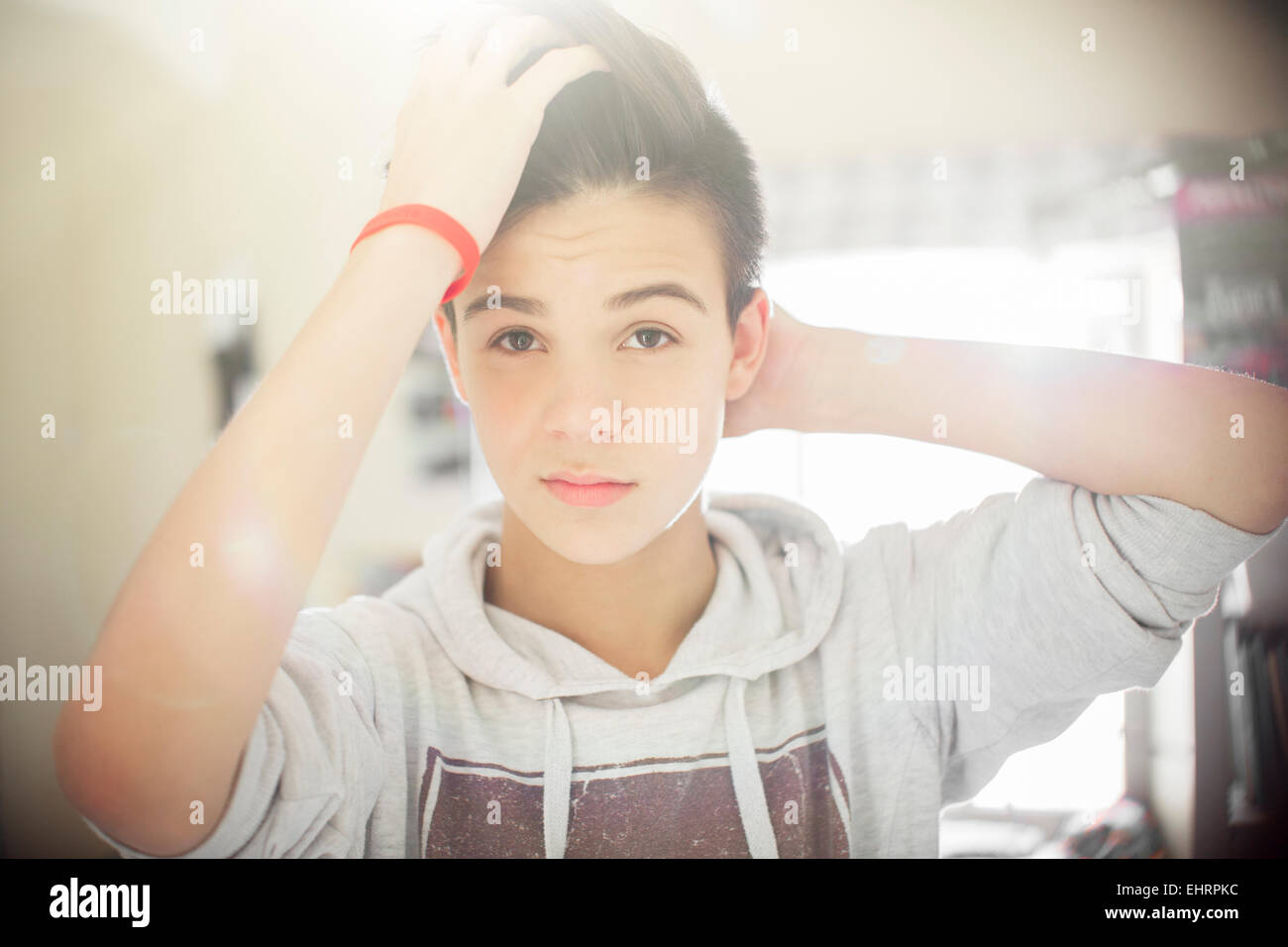 Portrait of teenage boy with hand in hair Stock Photo