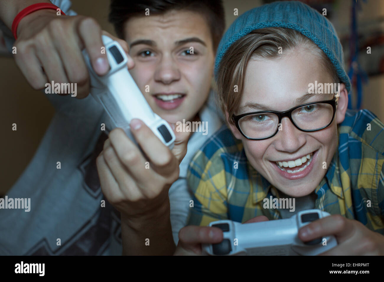 Two teenage boys playing together video game Stock Photo