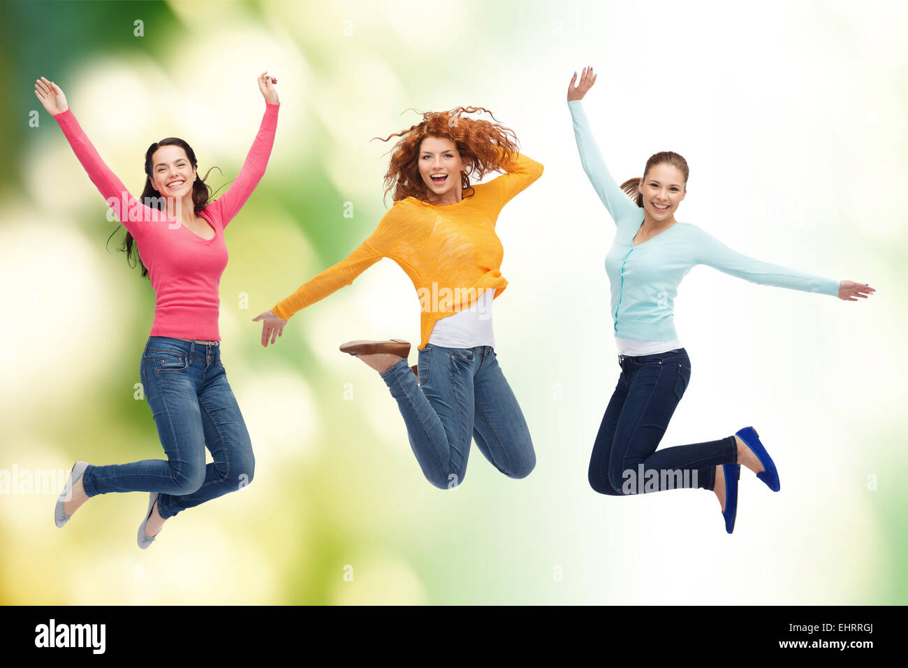 group of smiling young women jumping in air Stock Photo - Alamy