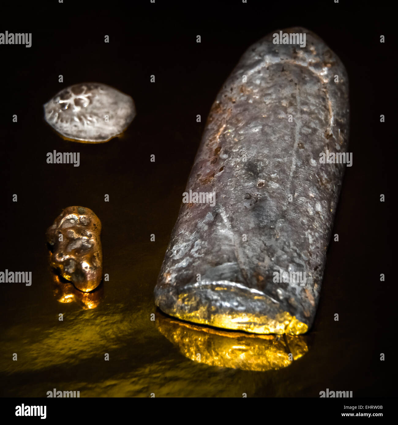 ancient bars of silver lie on a golden background Stock