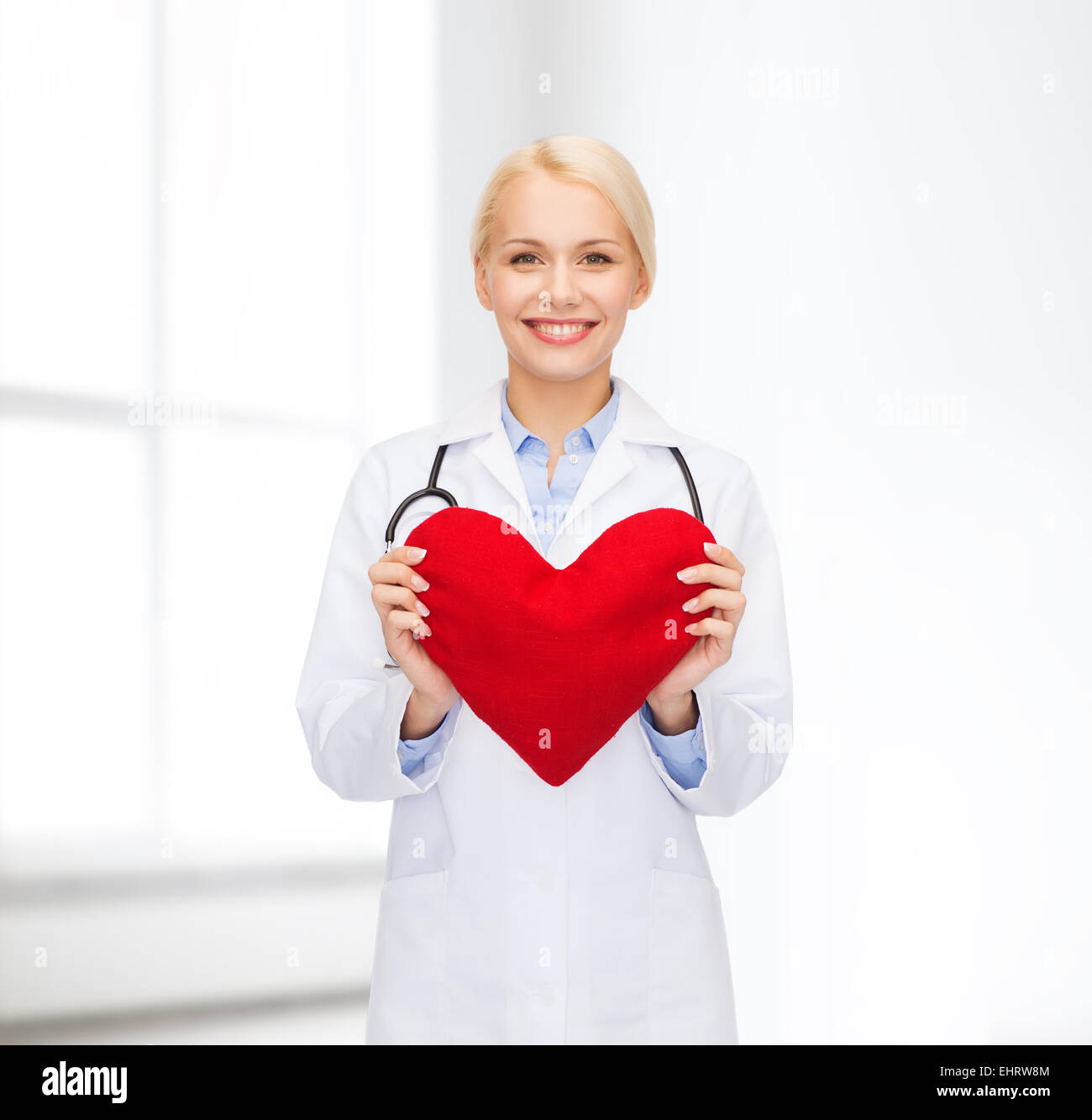 smiling female doctor with heart and stethoscope Stock Photo - Alamy