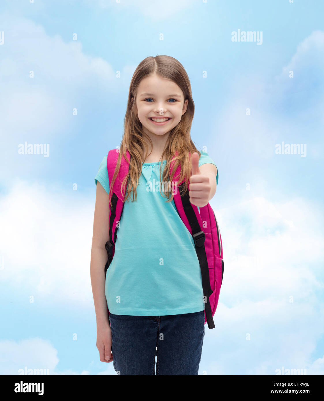 smiling girl with school bag showing thumbs up Stock Photo - Alamy