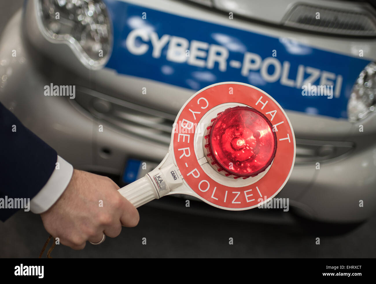 Police Signalling Disc Hanover, Germany. 16th Mar, 2015. ILLUSTRATION - A man holds a police ...