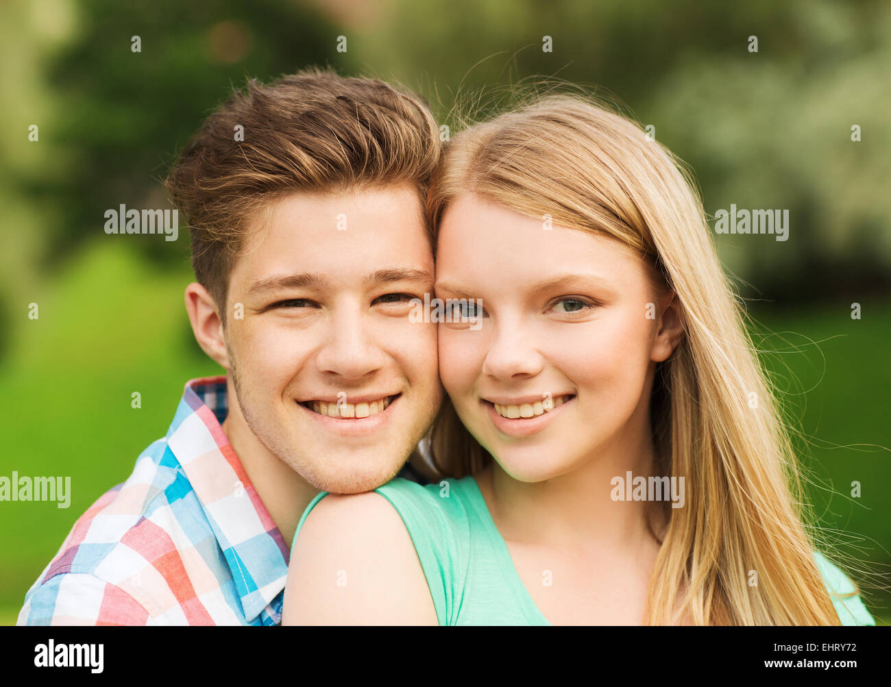 smiling couple hugging in park Stock Photo - Alamy