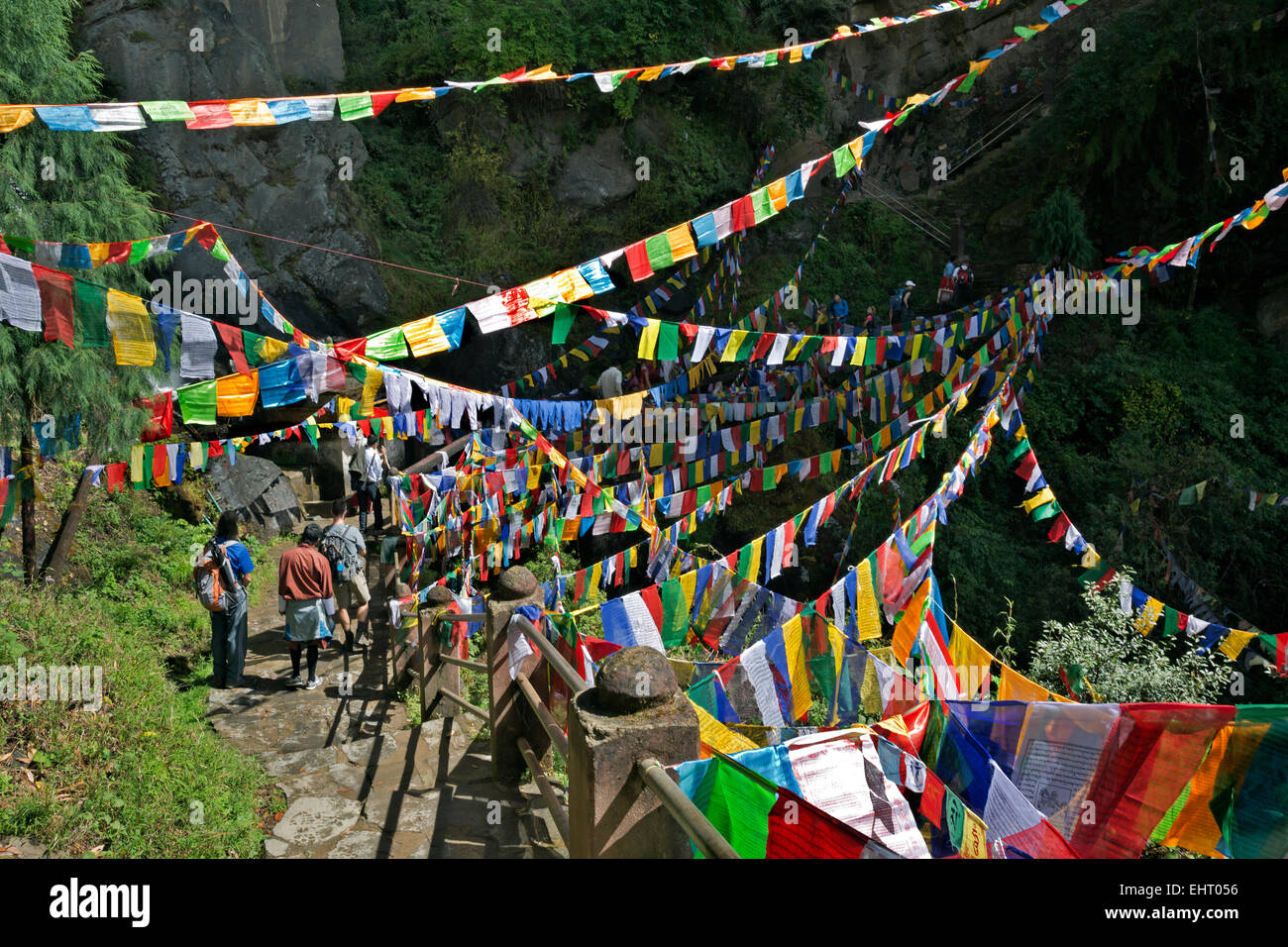 BHUTAN - A plethora of prayer flags by a waterfall near the entrance to Taktshang Goemba, (the Tiger's Nest Monastery). Stock Photo