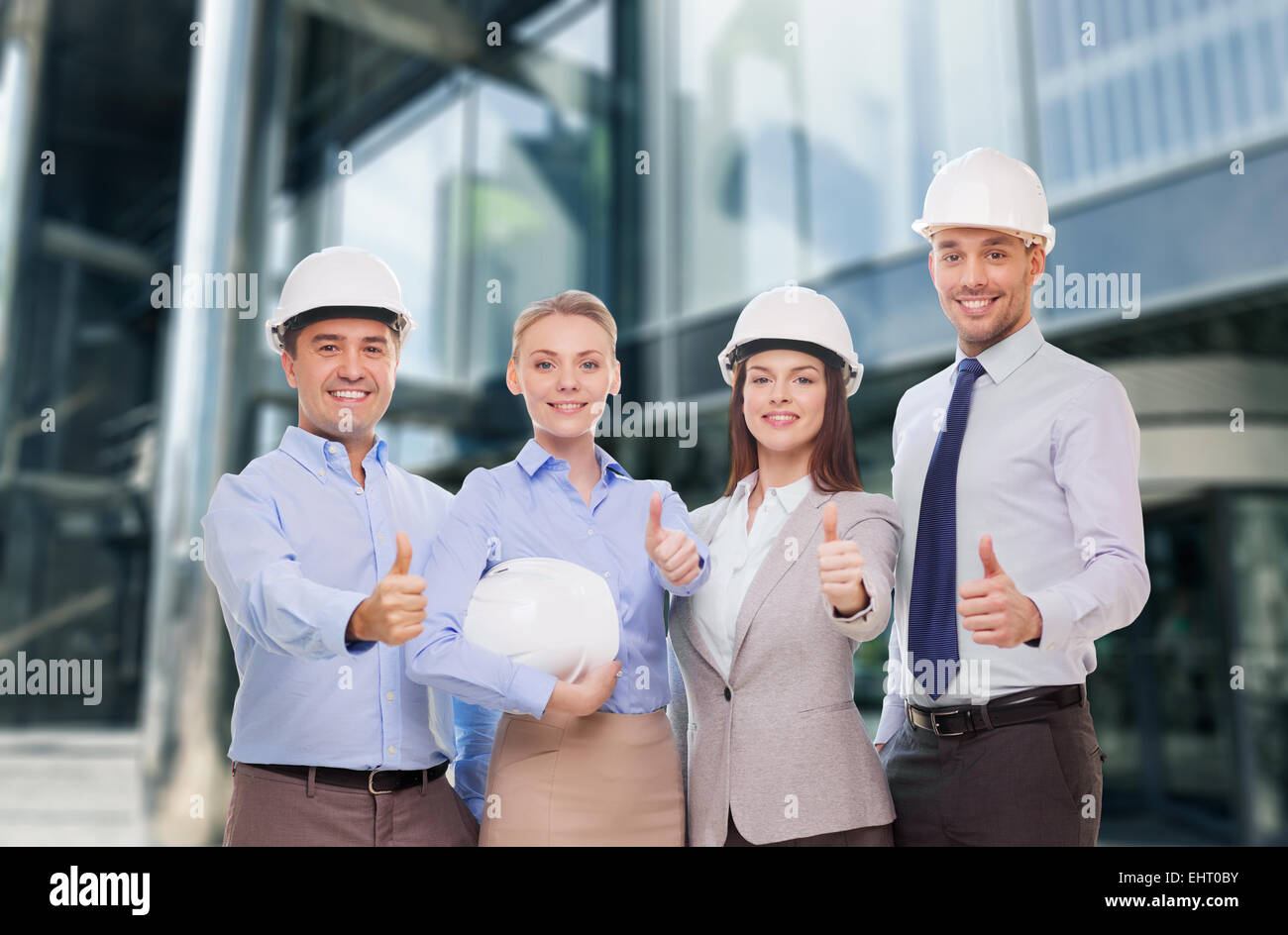 happy business team in office showing thumbs up Stock Photo - Alamy