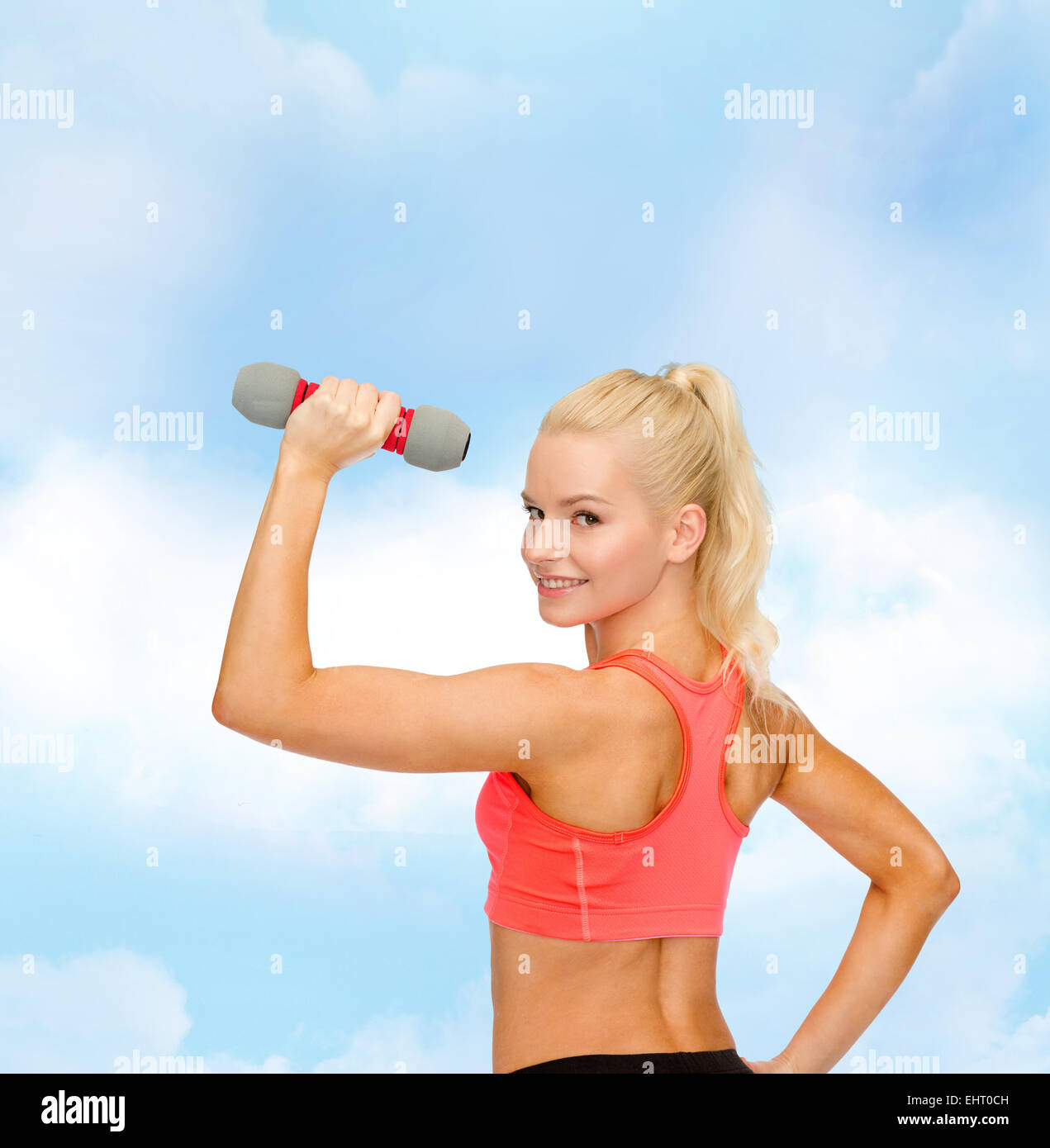 young sporty woman with light dumbbell Stock Photo