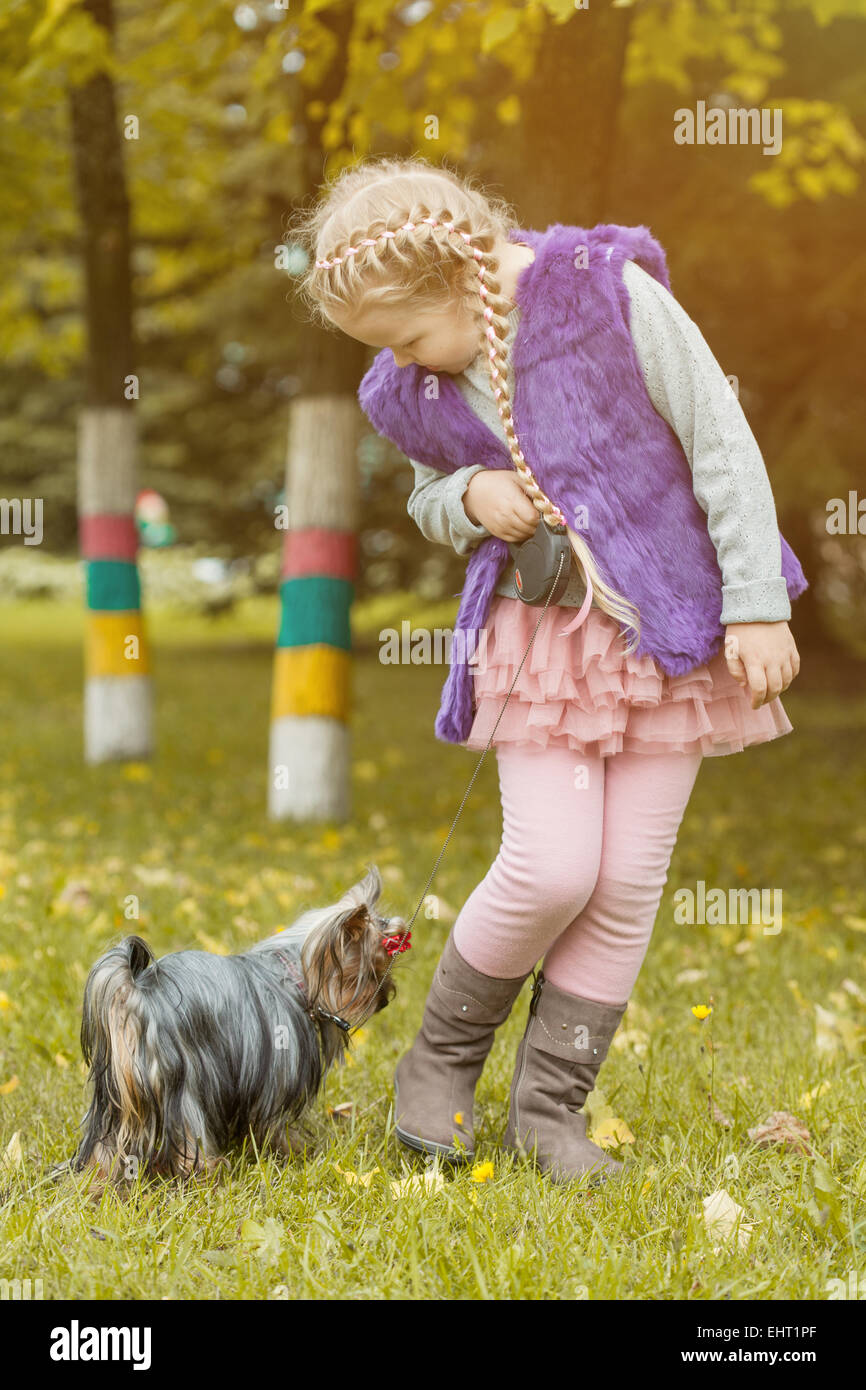 Adorable little girl playing with her puppy Stock Photo