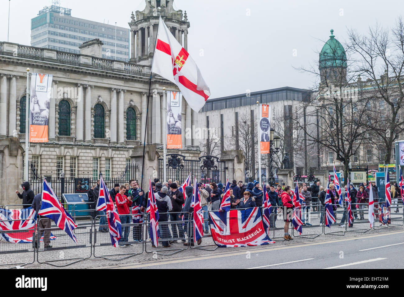 Rival groups of republicans draped in Irish Tricolors and Unionists waving Union Flags face each other in front of City Hall. Stock Photo