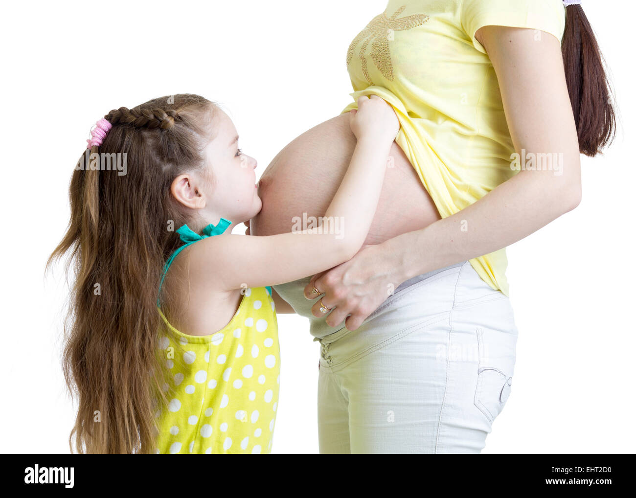 Cute child girl embracing pregnant mother belly Stock Photo