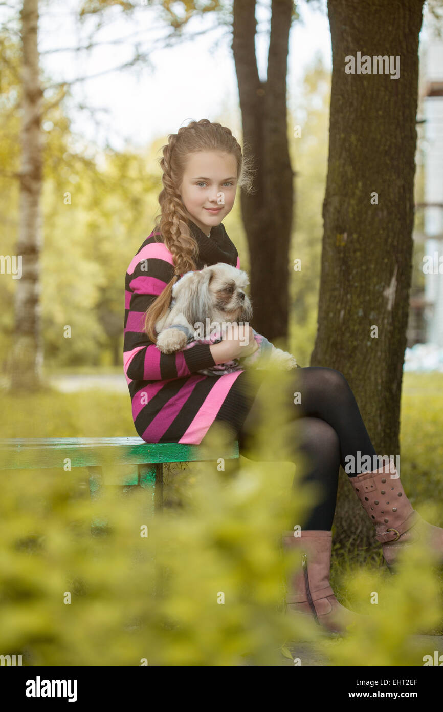 Beautiful little girl holding cute puppy Stock Photo