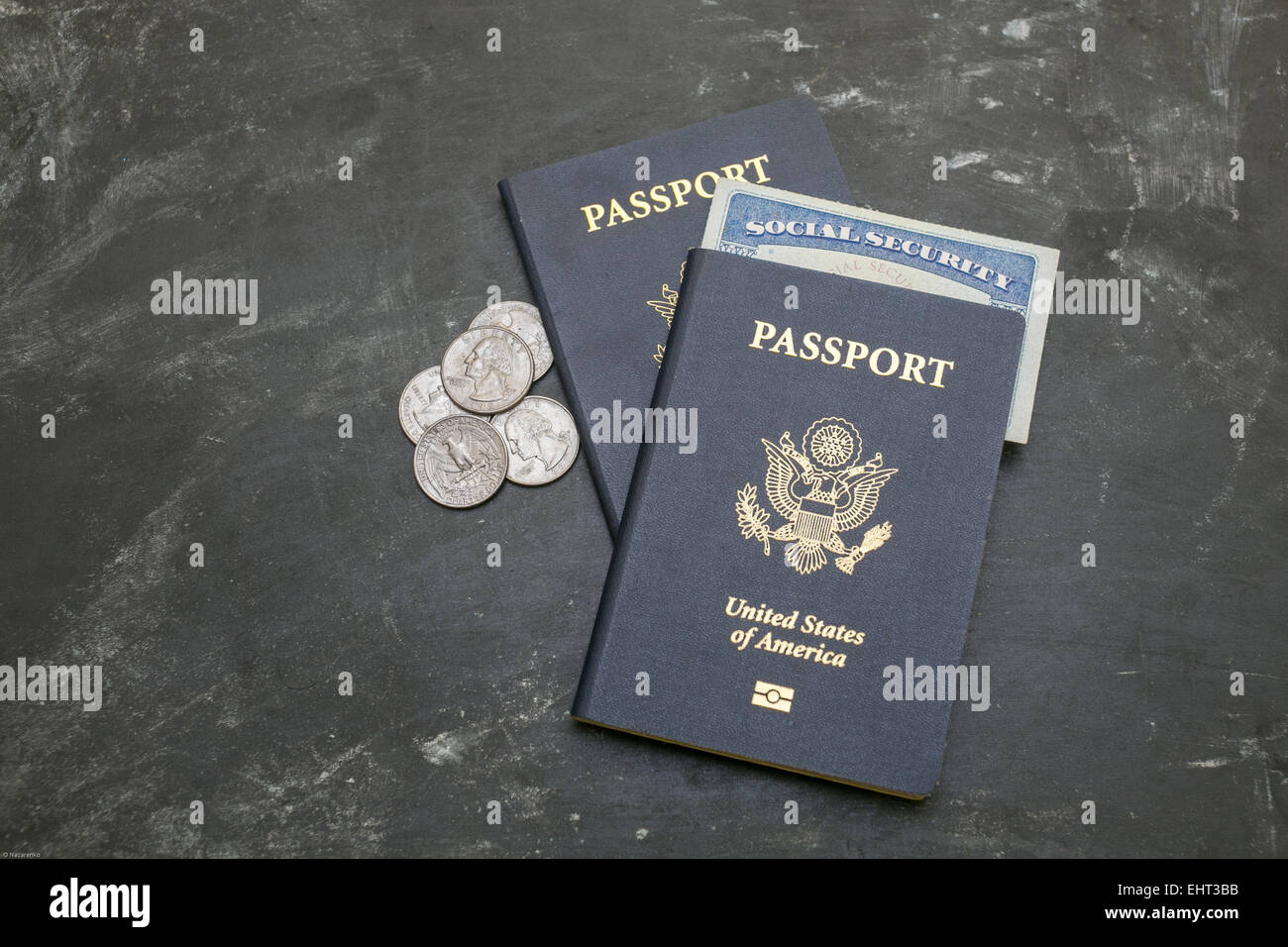 Two US passports on black background. American citizenship. Social security card in a document. Traveling around the world. Coin Stock Photo