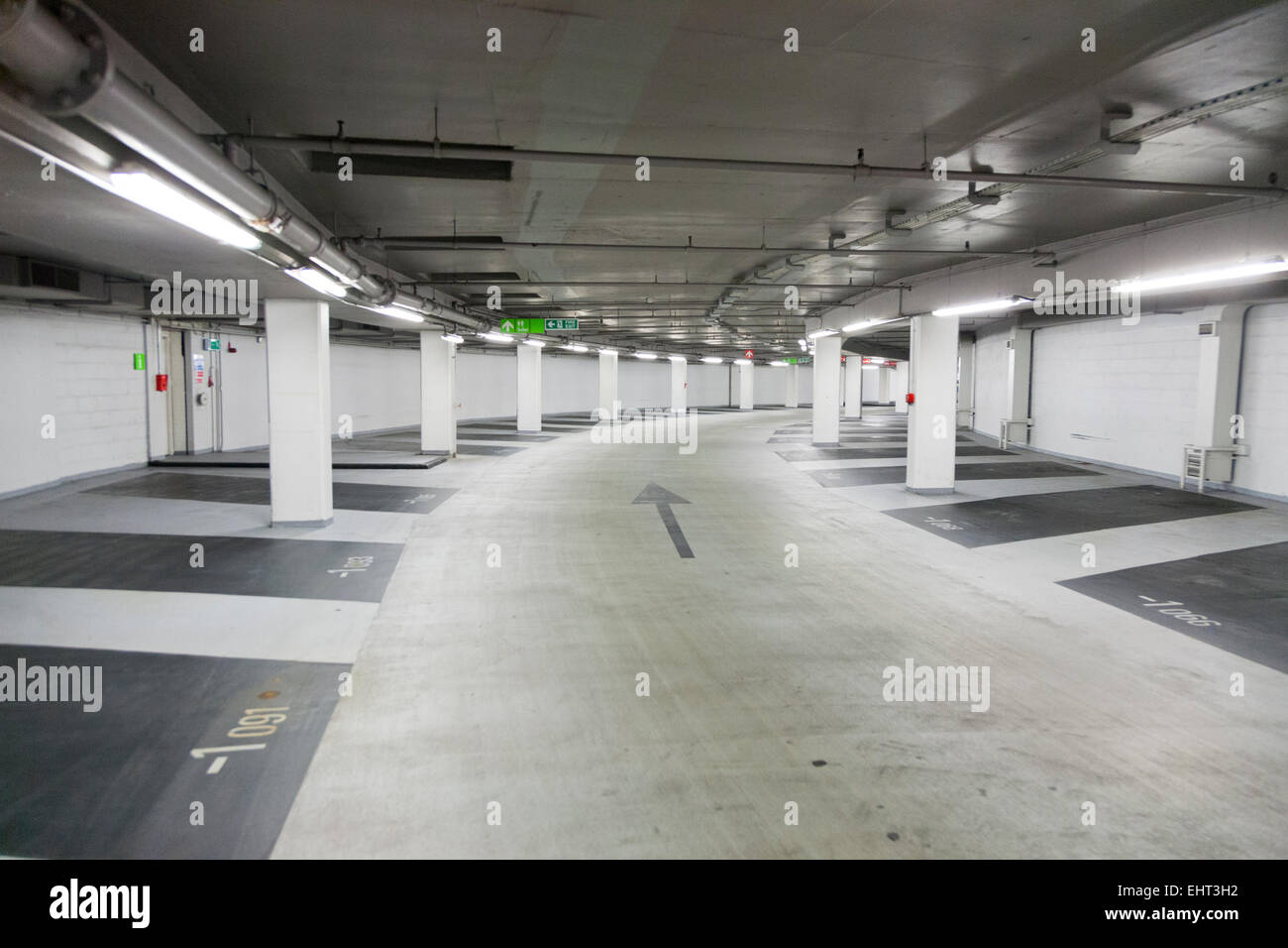 Inside & empty vacant parking bays in underground multi storey / level car park operated by Q park. Cavendish Square. London UK Stock Photo