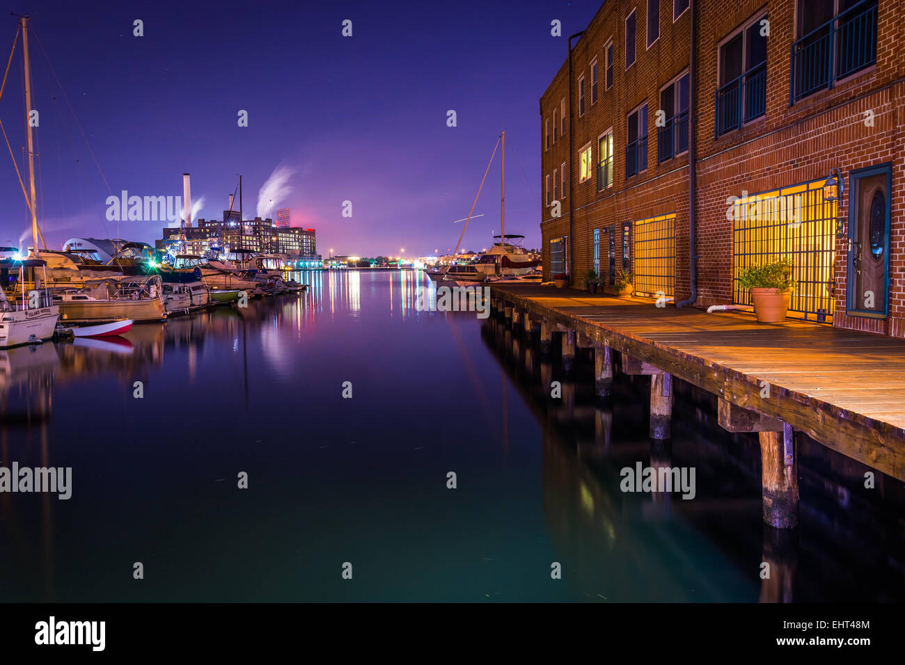 Apartment building and marina at night on the waterfront in Fells Point