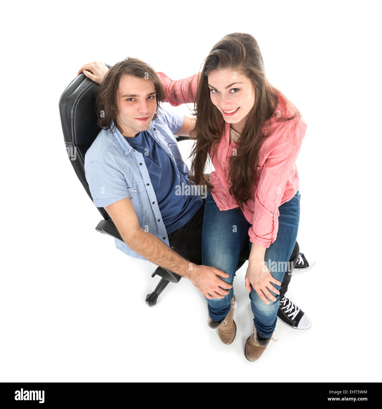 Top view of man and woman sitting together in armchair, isolated over white Stock Photo