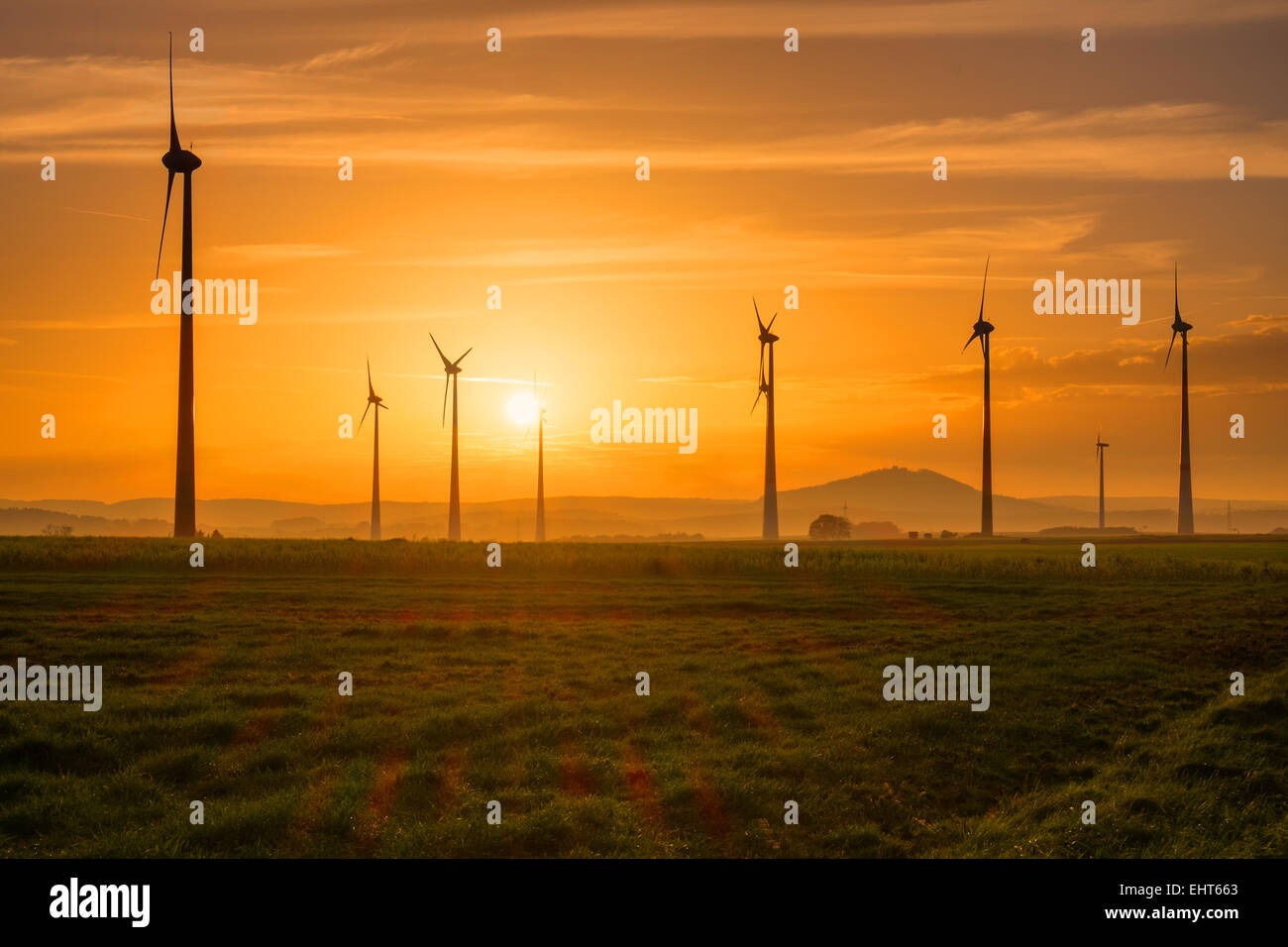 Several wind engines at sunset seen in Germany Stock Photo