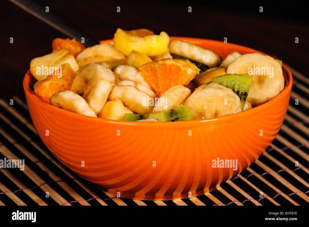 Mixed fruit salad, orange bowl, fresh healthy diet Stock Photo