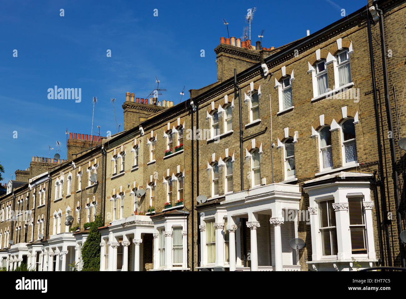 Typical quiet suburban residential street with Victorian Terraced houses in the capital. Shot runs top right to bottom left. Stock Photo