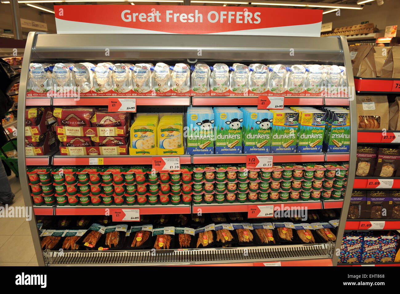 Supermarket fridge shelf with offers in a Morrisons local supermarket