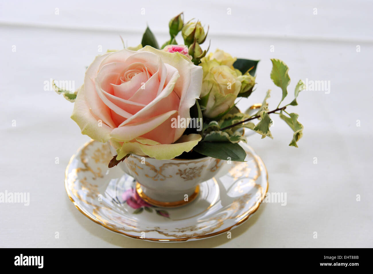 flowers in a vintage tea cup at a wedding. Stock Photo