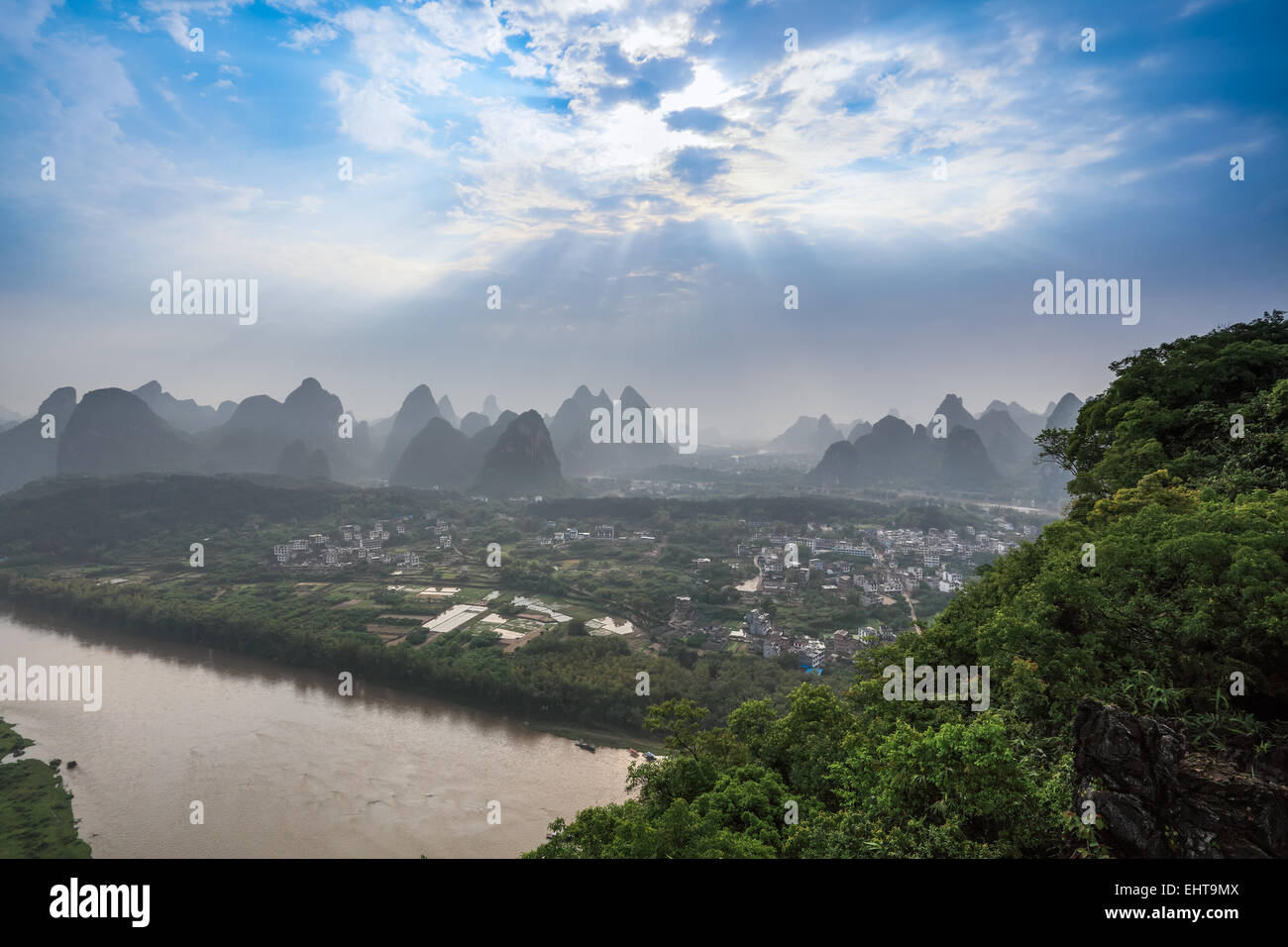 karst mountain landscape with sunlight through the clouds Stock Photo