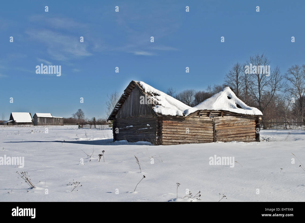 Old barn with a sagging roof in winter Stock Photo