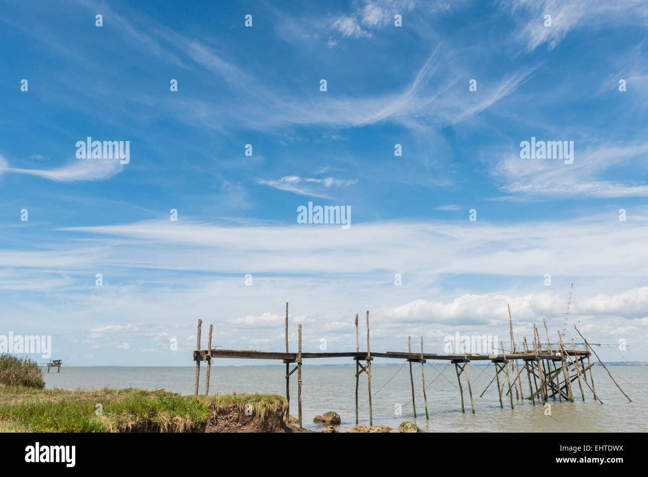 Wooden jetty for fishing in the Gironde Medoc France with blue sky and white clouds. Stock Photo