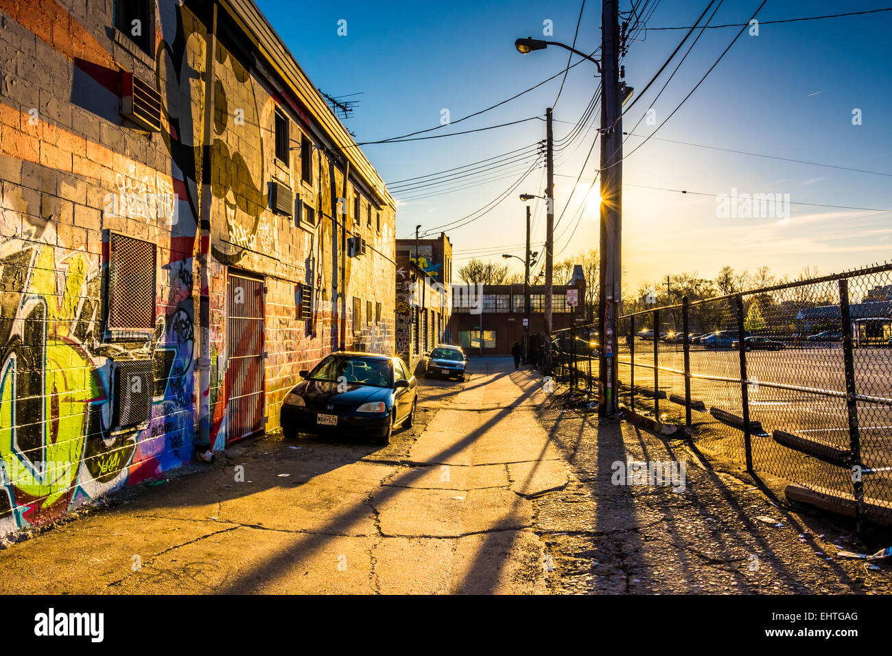 Cars parked in Graffiti Alley at sunset, in Baltimore, Maryland Stock ...