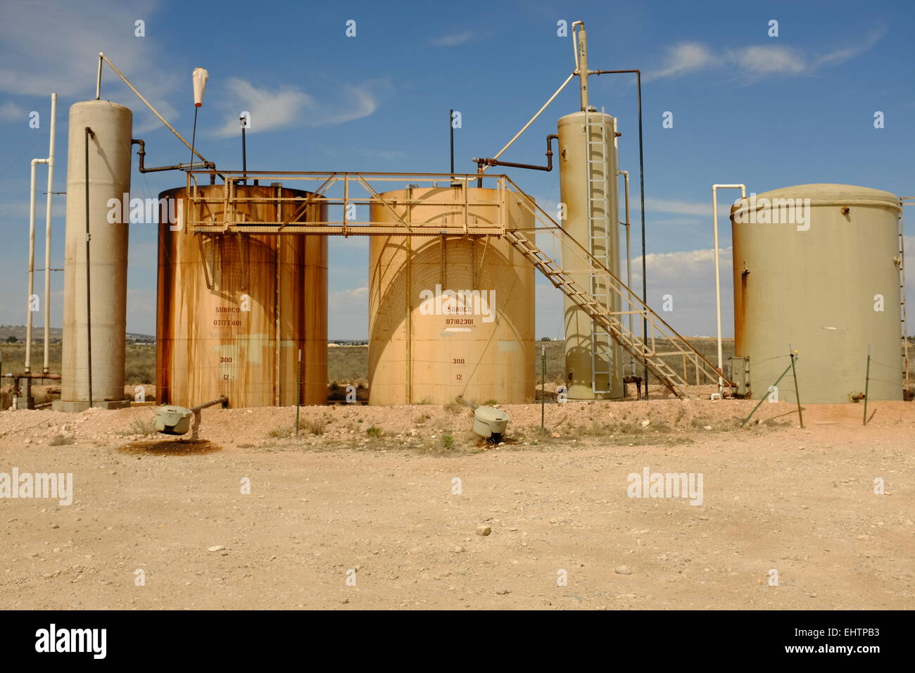 Tank farm in Oil field near Carlsbad, New Mexico, and field equipment