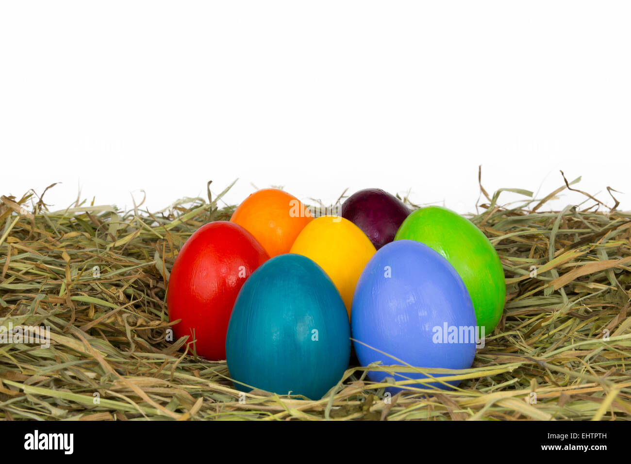 coloured easter eggs in hay and straw 5 Stock Photo