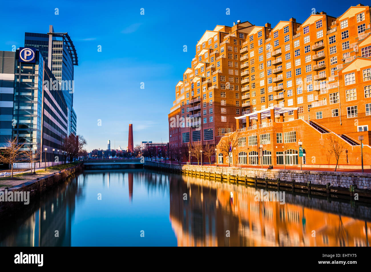 Parking garage and apartment building reflecting in water at the Inner ...