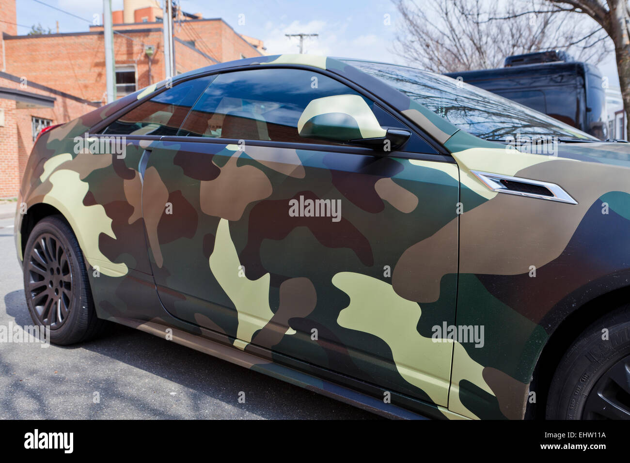 Car with military camouflage pattern wrap - USA Stock Photo
