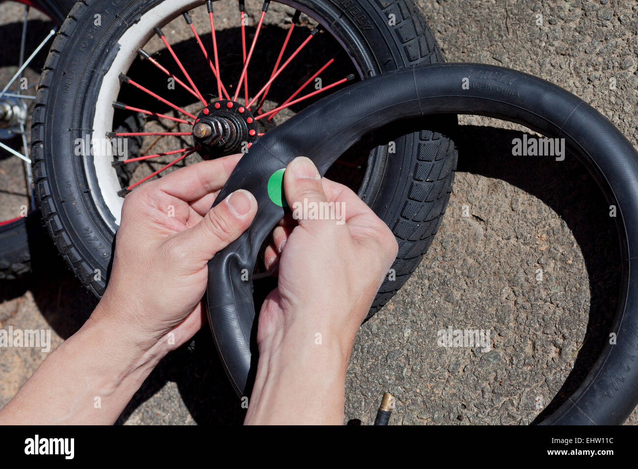 Man patching child's bicycle tire - USA Stock Photo