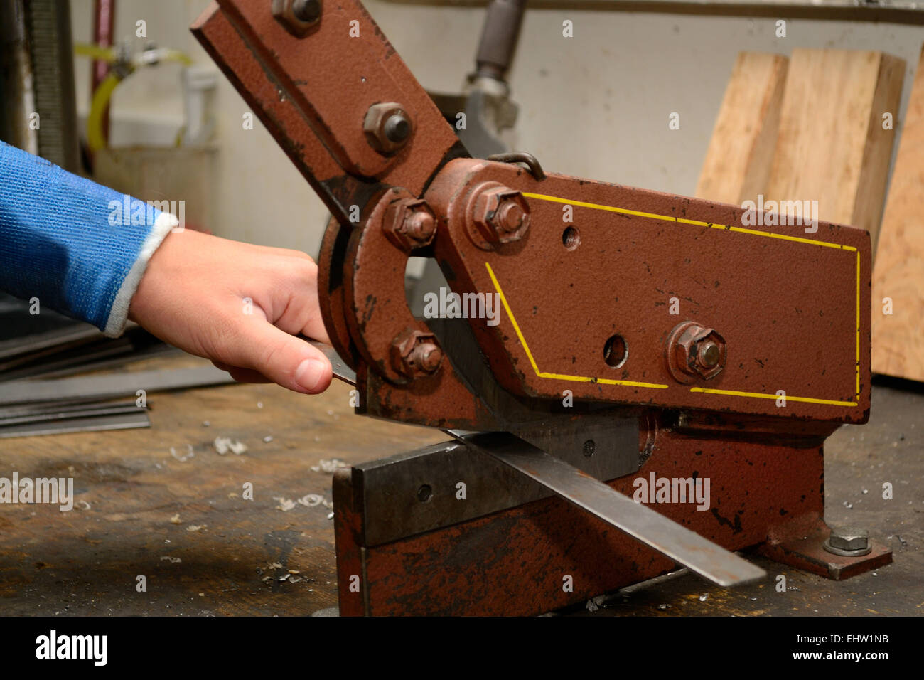 Person cuts metal with lever shears Stock Photo