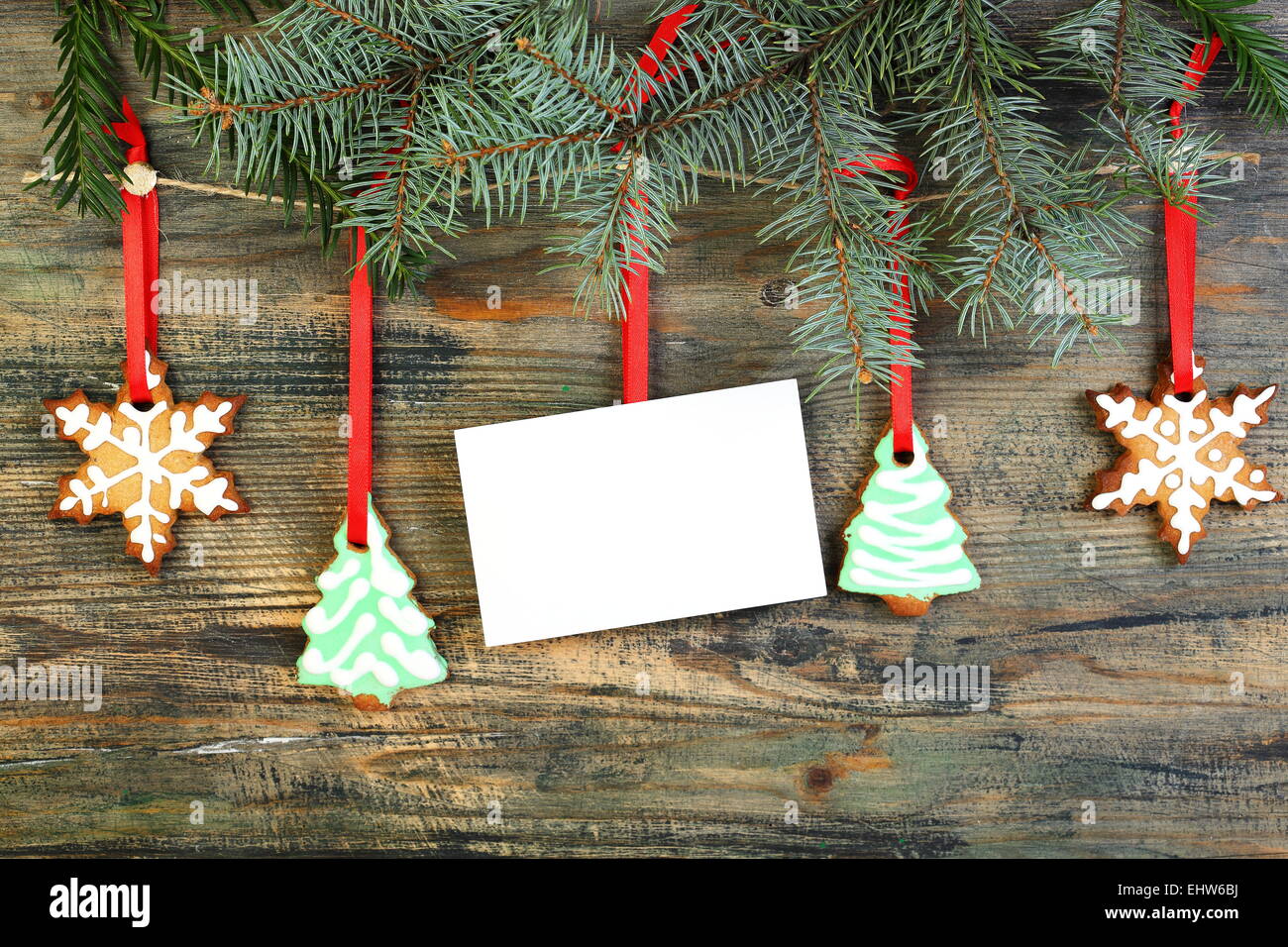 Card and Christmas cookies on fir branches. Stock Photo