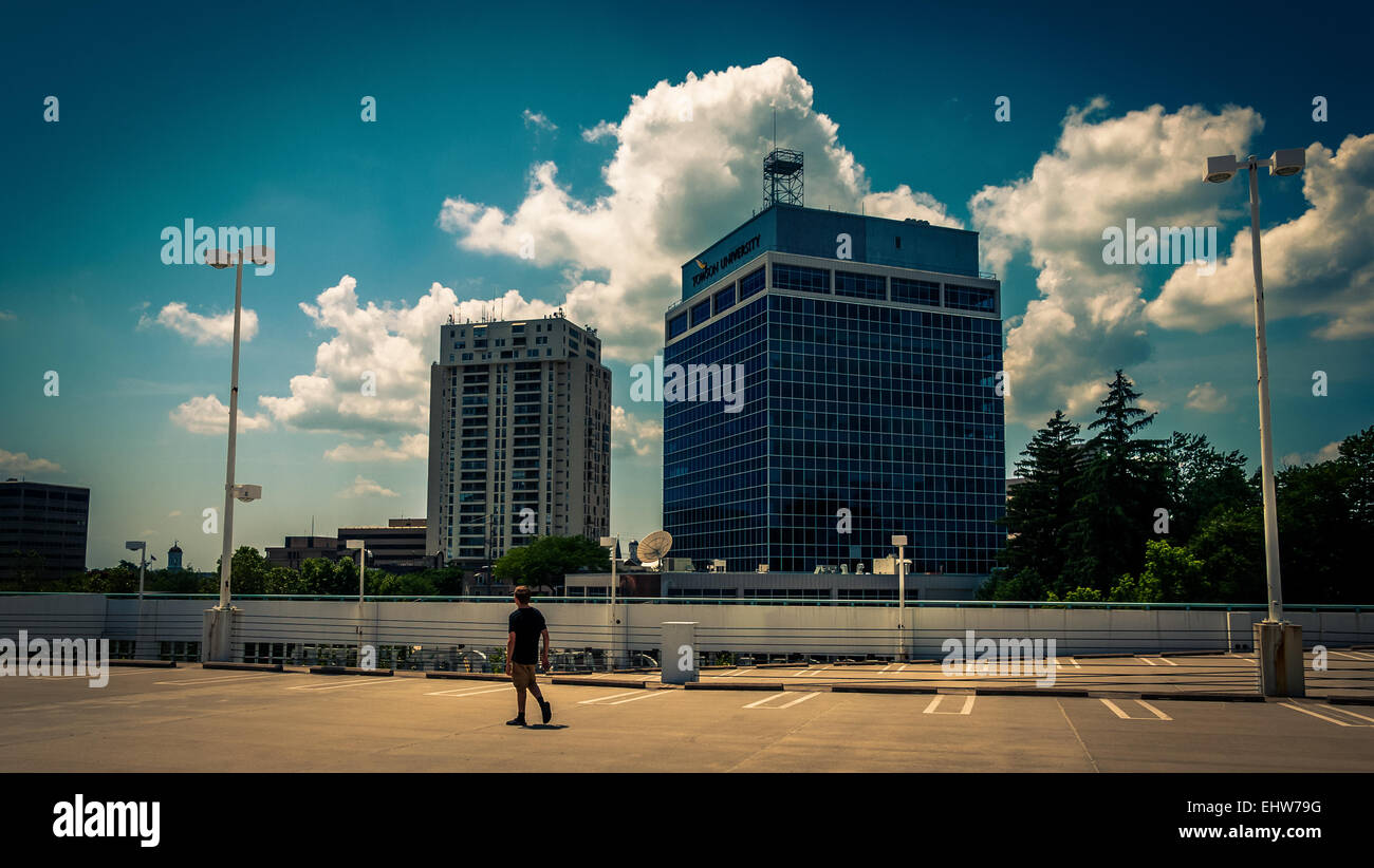 View of highrises and a man walking on a parking garage in Towson, Maryland. Stock Photo
