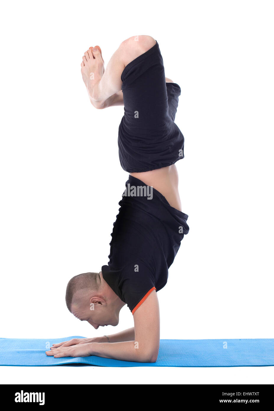 Image of calm man doing yoga handstand Stock Photo
