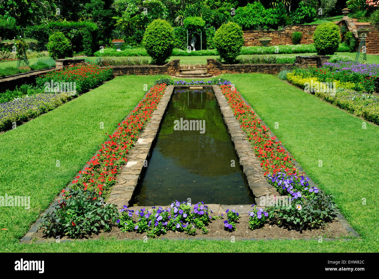 Durban, KwaZuluNatal, South Africa, colourful seedlings on border of water feature, traditional