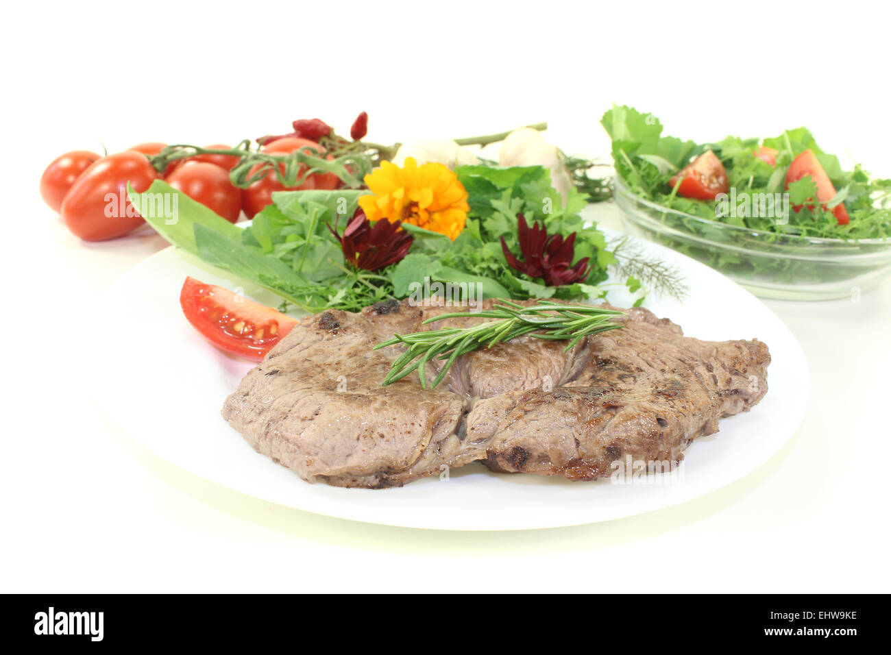 fried ribeye steak with wild herb salad Stock Photo