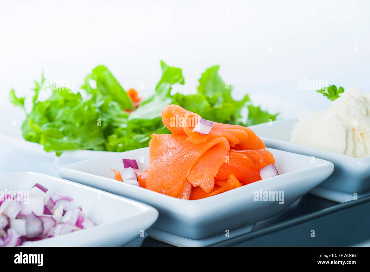 Smoked Salmon Lox platter with red onion, and cream cheese Stock Photo