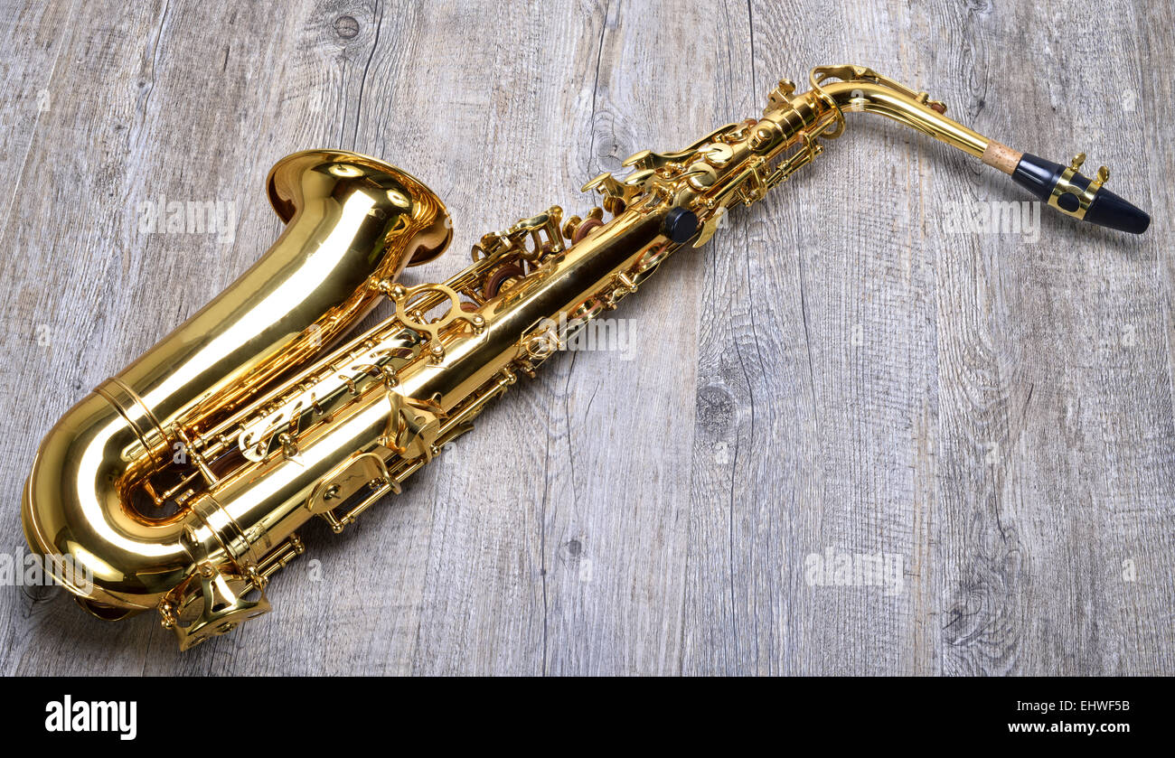 Saxophone on the wooden table Stock Photo