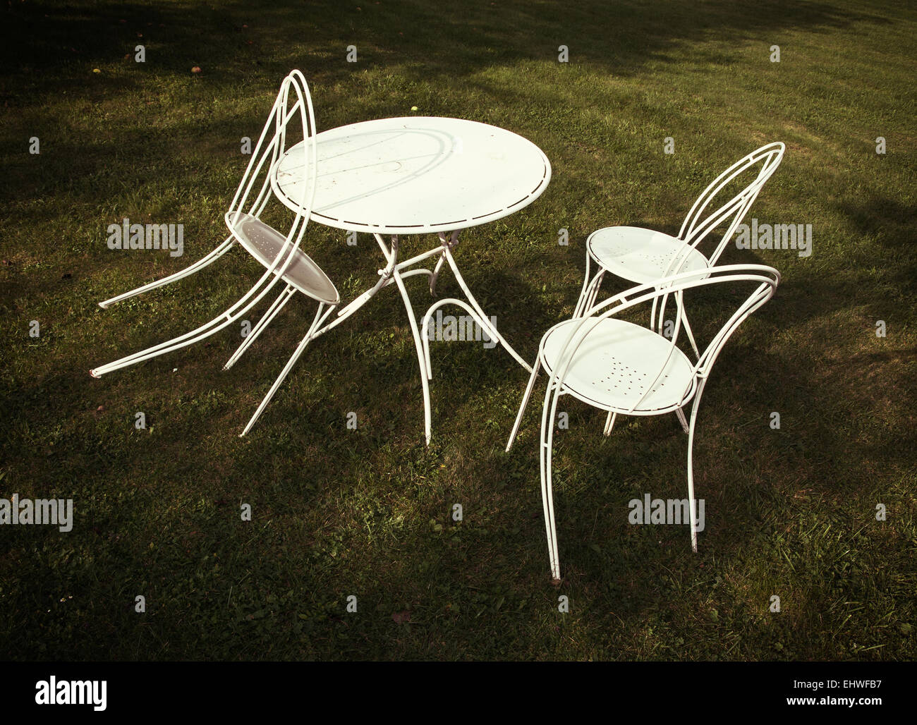 White metal table and chairs on the lawn. Garden party Stock Photo Alamy