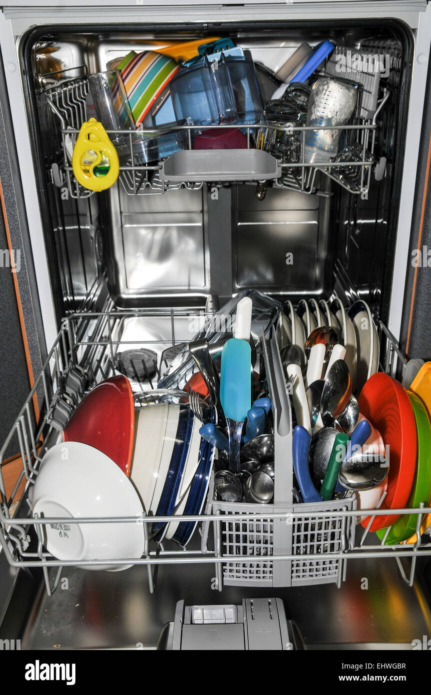 Dish washer stacked with dishes, cups and cutlery Stock Photo Alamy