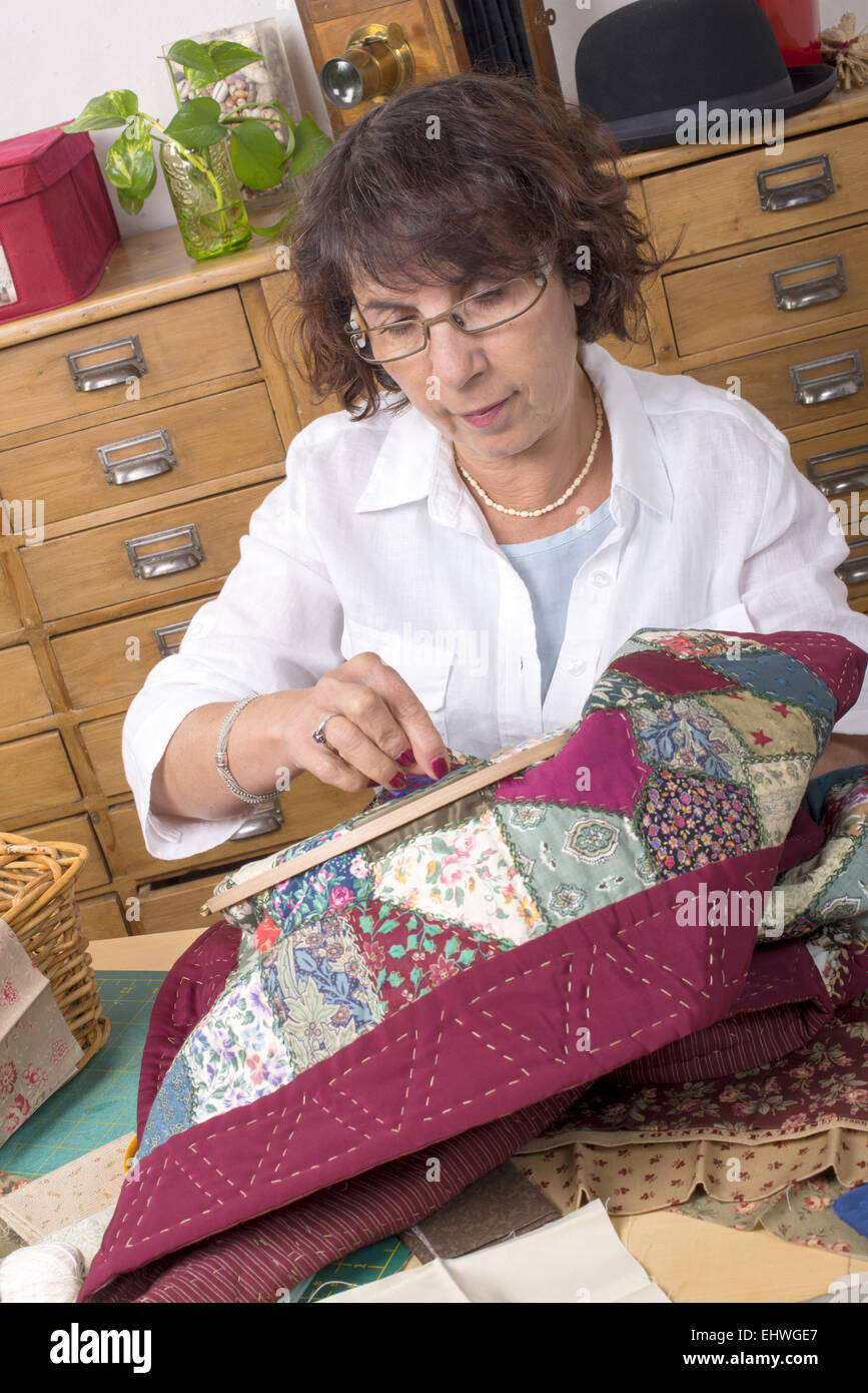 Mature woman by sewing and quilting in her home Stock Photo - Alamy