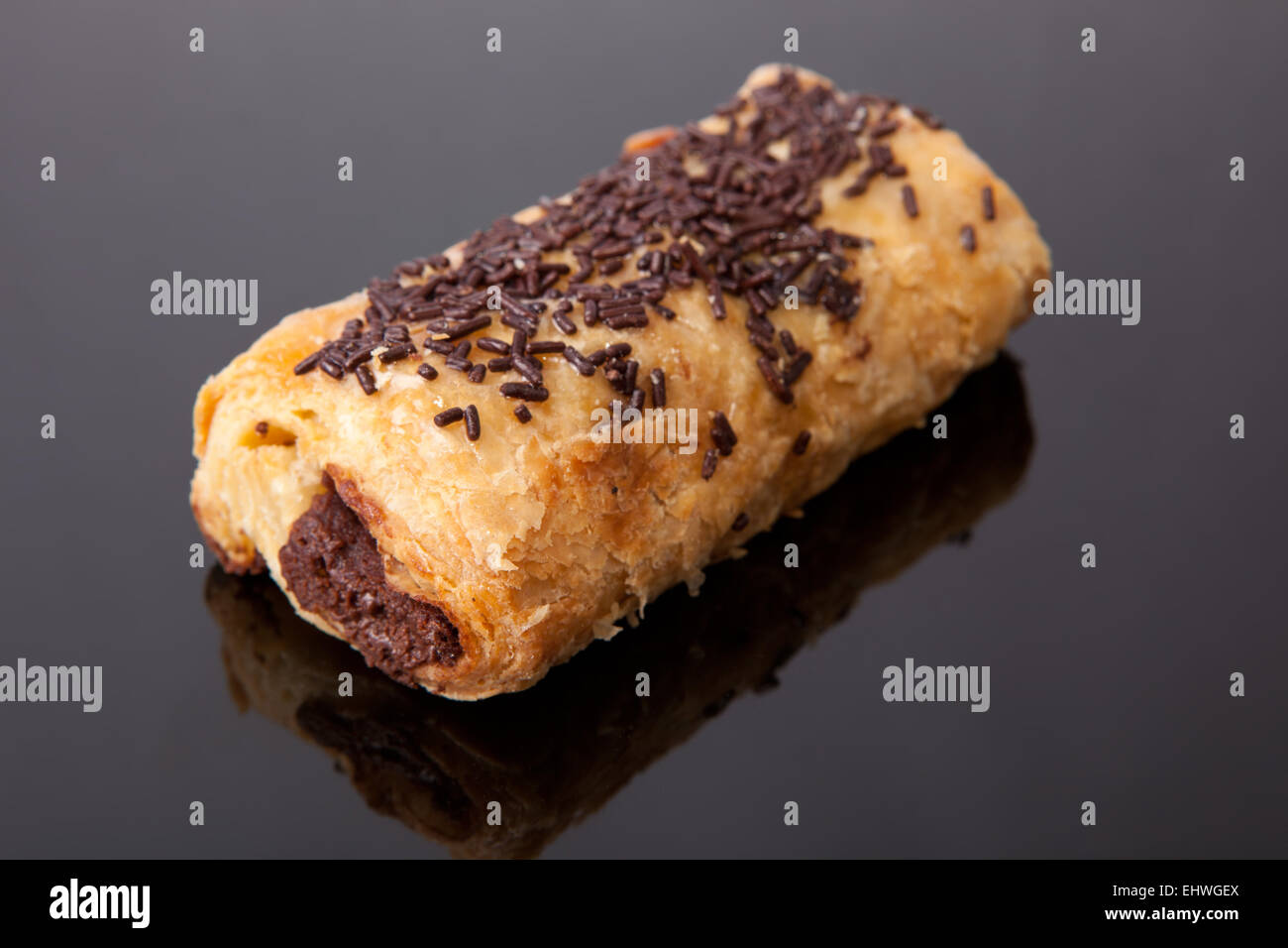 Closeup of a pain au chocolat or napolitana. Isolated on a black background Stock Photo