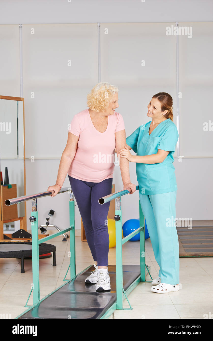 Physiotherapy with walking exercise on treadmill for senior woman Stock Photo