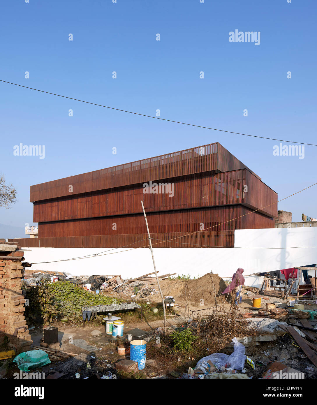 Overall view from adjacent vacant plot with the builders (and family). The Lattice house, Jammu Khashmir, India. Architect: SP+A Stock Photo