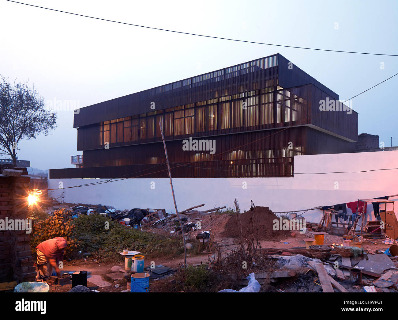 Overall view from adjacent vacant plot with the builders (and family). The Lattice house, Jammu Khashmir, India. Architect: SP+A Stock Photo