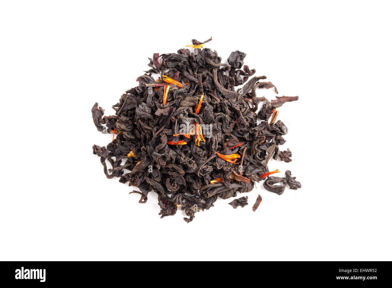Small pile of big leaf black tea mixed with safflower and hibiscus petals isolated on white background, top view Stock Photo